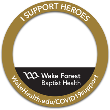 A gold circle with the Wake Forest Baptist Health logo inside and the words 'I Support Heroes' across the top