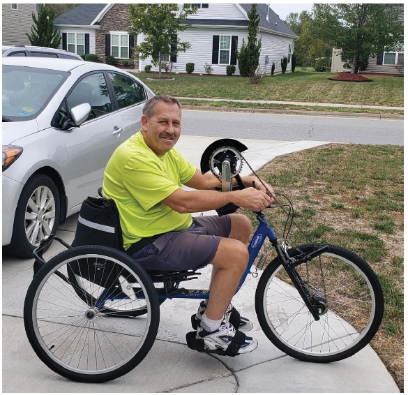 Bruce Lambert, a trauma survivor, rides his bike.
