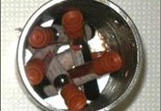 Six glass blood tubes inside a metal can with no packing or absorbent material. 