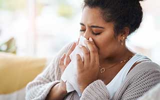 Woman sneezing