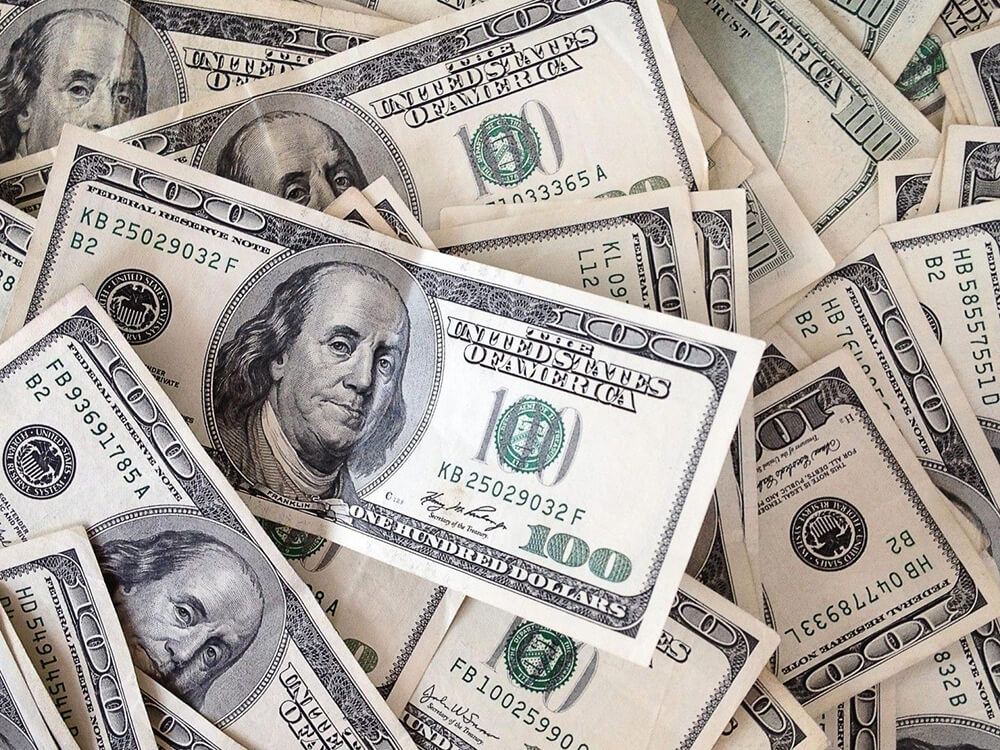 A large pile of 100 dollar bills.
